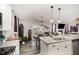 This bright kitchen features stainless steel appliances, a granite island, and backyard views at 152 Briar Den Ct, Benson, NC 27504