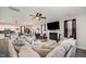 Living room with fireplace, fan, and a large comfortable seating arrangement open to the kitchen at 152 Briar Den Ct, Benson, NC 27504