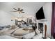 Open-concept living room featuring a fireplace, large sectional sofa, and ceiling fan at 152 Briar Den Ct, Benson, NC 27504