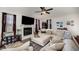 Comfortable living room featuring a fireplace, large sofa, and a flat-screen television at 152 Briar Den Ct, Benson, NC 27504
