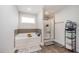 Well-lit main bathroom with a soaking tub, walk-in shower, and tiled accents at 152 Briar Den Ct, Benson, NC 27504