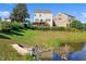 Backyard view with lush greenery, a pond, and a home featuring an outdoor deck at 1600 Tinos Overlook Way, Apex, NC 27502