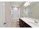 Bathroom featuring a vanity with a large mirror and a tub with shower at 1600 Tinos Overlook Way, Apex, NC 27502