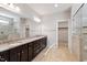 Bright bathroom featuring a granite-topped vanity and a glass-enclosed shower at 1600 Tinos Overlook Way, Apex, NC 27502