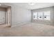 Spacious bedroom with neutral carpeting, three windows providing natural light at 1600 Tinos Overlook Way, Apex, NC 27502