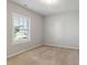Bedroom featuring a window and neutral carpet, bathed in natural light at 1600 Tinos Overlook Way, Apex, NC 27502