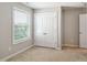 Neutral bedroom featuring plush carpeting, white trim, and ample closet space by the bright window at 1600 Tinos Overlook Way, Apex, NC 27502