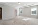 Main bedroom featuring neutral walls, carpet, and multiple windows for natural light at 1600 Tinos Overlook Way, Apex, NC 27502