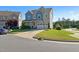 Charming two-story home with a two-car garage, blue accents, and a well-maintained front yard at 1600 Tinos Overlook Way, Apex, NC 27502