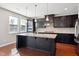 Kitchen featuring dark cabinets, granite countertops, stainless steel appliances, and an island at 1600 Tinos Overlook Way, Apex, NC 27502