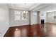 Open-concept living room with hardwood floors, fireplace, coffered ceiling, and lots of natural light at 1600 Tinos Overlook Way, Apex, NC 27502