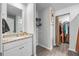 Bathroom featuring granite countertops, soft closing cabinets, and a view into the walk-in closet at 165 Bywood Dr, Roxboro, NC 27573