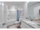 A bathroom featuring a shower and tub combo, white toilet, and granite countertop sink at 165 Bywood Dr, Roxboro, NC 27573