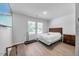 Bright bedroom featuring a queen bed, two windows, and hard surface flooring at 165 Bywood Dr, Roxboro, NC 27573