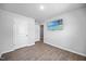 A bedroom featuring laminated floors, a window, and a wall-mounted television at 165 Bywood Dr, Roxboro, NC 27573