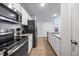 Modern kitchen with stainless steel appliances, granite countertops, and white cabinetry at 165 Bywood Dr, Roxboro, NC 27573
