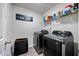 The laundry room features a laundry sorter and modern front load machines at 165 Bywood Dr, Roxboro, NC 27573