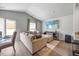 Comfortable living room with plush seating, large windows, and a mounted television at 165 Bywood Dr, Roxboro, NC 27573