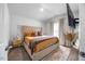 A main bedroom with a window and wall-mounted television at 165 Bywood Dr, Roxboro, NC 27573