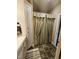 Bathroom featuring a shower with decorative curtain, tiled floor, and built in storage at 1655 Kingfisher Ct, Nashville, NC 27856