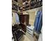 Walk in closet with shelves, drawers, hanging clothes and a chair at 1655 Kingfisher Ct, Nashville, NC 27856