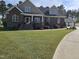 Beautiful two-story brick home with a lush lawn and manicured landscaping at 1655 Kingfisher Ct, Nashville, NC 27856