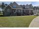 Beautiful two-story brick home with a lush lawn and manicured landscaping at 1655 Kingfisher Ct, Nashville, NC 27856