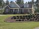Charming brick home featuring manicured landscaping, complemented by mature trees and a classic architectural design at 1655 Kingfisher Ct, Nashville, NC 27856