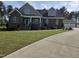 Two-story brick home boasts a lush lawn and meticulous landscaping at 1655 Kingfisher Ct, Nashville, NC 27856