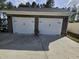 Attached two car garage with brick and two white doors at 1655 Kingfisher Ct, Nashville, NC 27856
