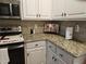 Kitchen featuring granite counters, white cabinetry, and stainless steel appliances at 1655 Kingfisher Ct, Nashville, NC 27856