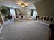 Large living room with a ceiling fan, multiple windows, and comfortable seating at 1655 Kingfisher Ct, Nashville, NC 27856