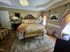 Main bedroom with wooden furniture, lamps, a decorative ceiling and an ensuite bathroom at 1655 Kingfisher Ct, Nashville, NC 27856