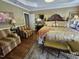 Main bedroom with wooden furniture, lamps, a decorative ceiling and an ensuite bathroom at 1655 Kingfisher Ct, Nashville, NC 27856