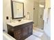 Well-lit bathroom features a dark wood vanity with marble top and a glass enclosed shower at 1707 Falls Church Rd, Raleigh, NC 27609