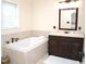 Elegant bathroom with a soaking tub, vanity, and modern fixtures at 1707 Falls Church Rd, Raleigh, NC 27609
