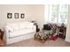 Relaxing space featuring a white daybed, colorful side chair, and large window with blinds at 1707 Falls Church Rd, Raleigh, NC 27609