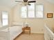 Upstairs bedroom featuring a white twin bed, neutral walls, and multi-pane windows at 1707 Falls Church Rd, Raleigh, NC 27609