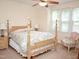 Comfortable bedroom with a wooden four-poster bed and bright, natural light at 1707 Falls Church Rd, Raleigh, NC 27609
