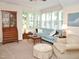 Inviting living room featuring a plush couch, chair and bay windows at 1707 Falls Church Rd, Raleigh, NC 27609