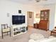 Spacious living room with TV and classic furniture including a book case at 1707 Falls Church Rd, Raleigh, NC 27609