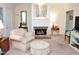 Cozy living room with a brick fireplace, plush seating, and neutral decor at 1707 Falls Church Rd, Raleigh, NC 27609