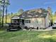 Back exterior with a screened in porch, concrete patio, and a small shed at 175 Lockamy Ln, Youngsville, NC 27596