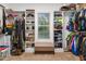 Spacious walk-in closet with custom shelving, hanging rods, bench, and natural light from a window at 175 Lockamy Ln, Youngsville, NC 27596