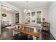 Bright and airy dining room featuring a large wooden table and bench seating at 175 Lockamy Ln, Youngsville, NC 27596
