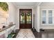 Inviting foyer with dark wood flooring, stylish rug, and elegant double doors at 175 Lockamy Ln, Youngsville, NC 27596