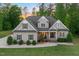 Charming two-story home featuring professional landscaping and a welcoming front porch with an American flag at 175 Lockamy Ln, Youngsville, NC 27596