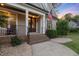 Inviting front porch with brick steps, decorative plants, rocking chairs, and an American flag at 175 Lockamy Ln, Youngsville, NC 27596