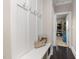 Hallway featuring a built-in bench and coat rack with a view into a playroom at 175 Lockamy Ln, Youngsville, NC 27596