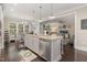 Open kitchen view with a large island, stainless steel appliances, and seamless connection to the living area at 175 Lockamy Ln, Youngsville, NC 27596